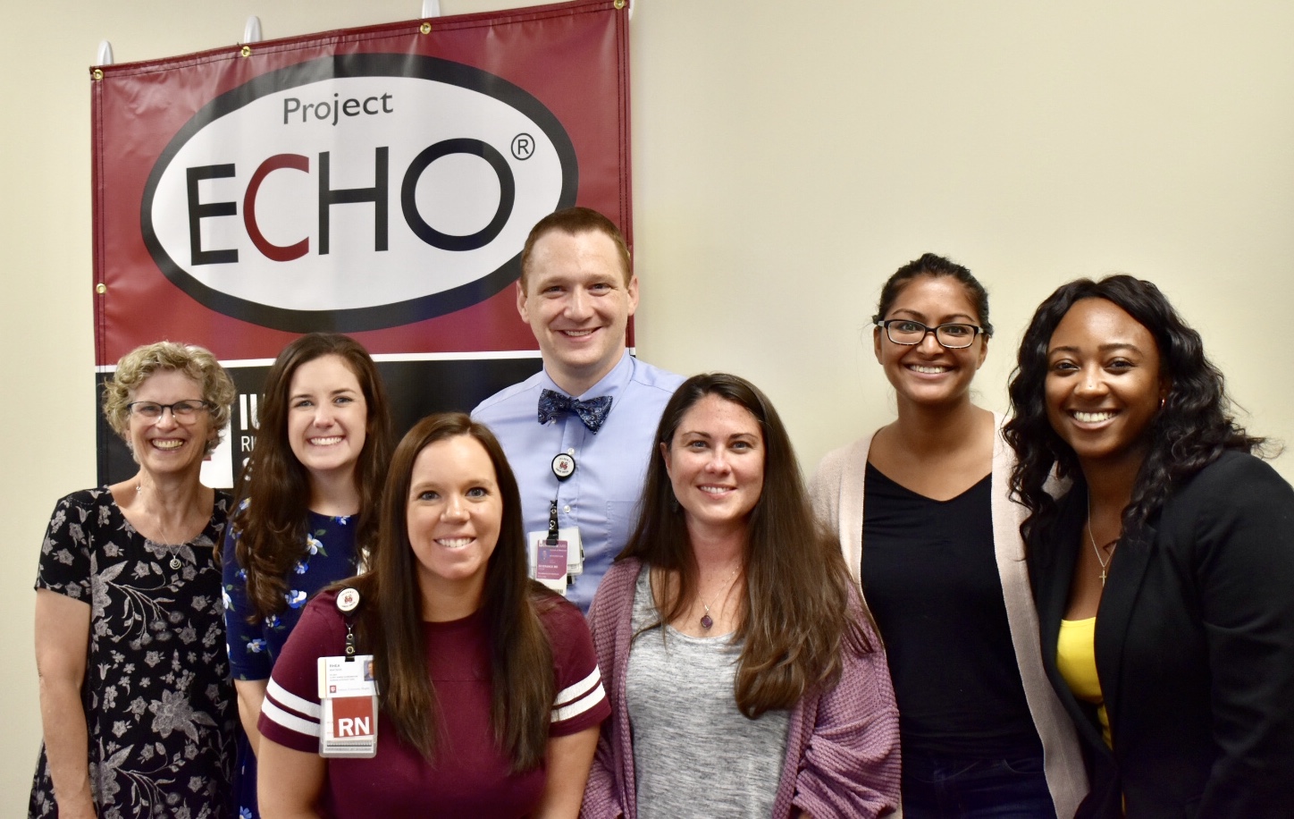 7 people standing in front of project echo sign